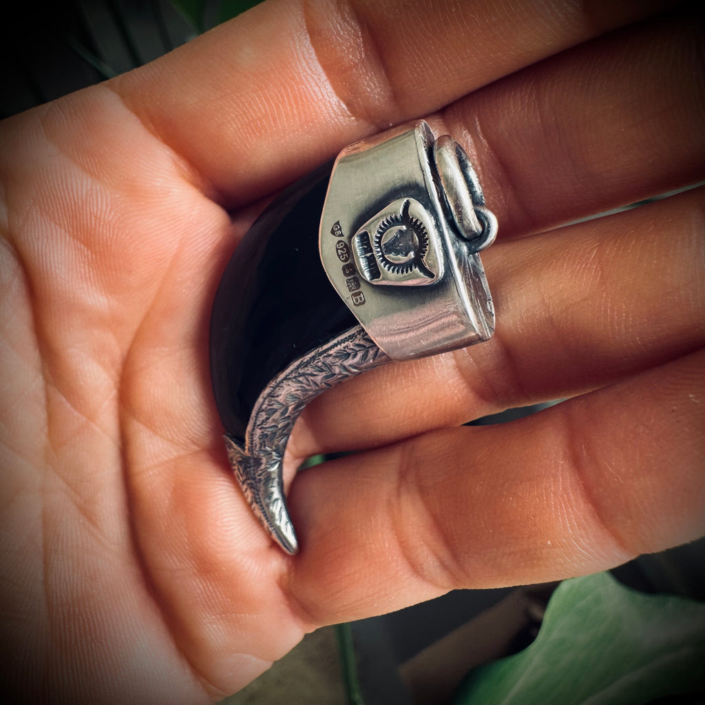 Carved onyx claw style pendant with turquoise in hallmarked sterling silver