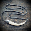 2.5” bone “tusk” on 16” antique guard chain in sterling silver