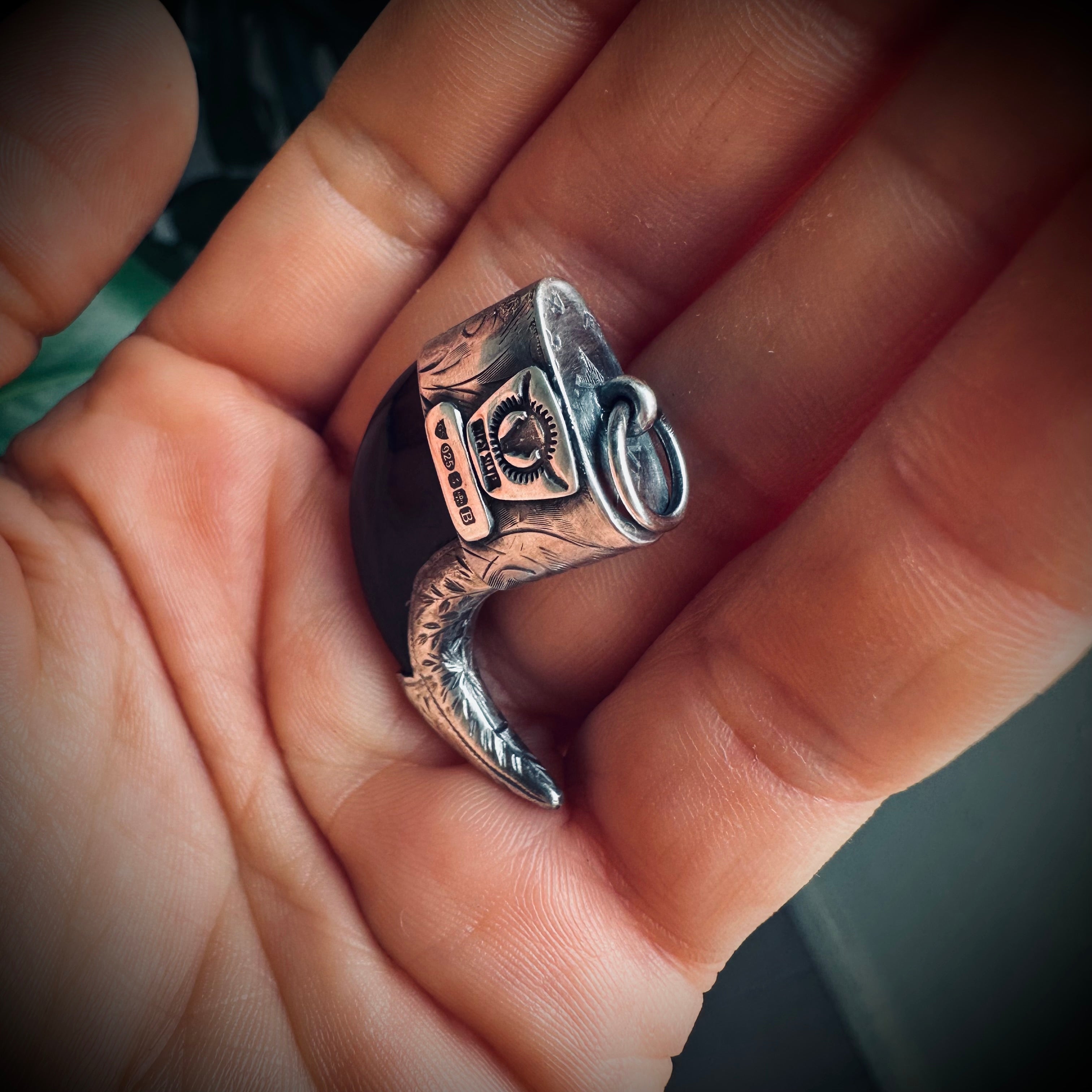 Carved buffalo horn “claw” pendant with turquoise in hallmarked sterling silver