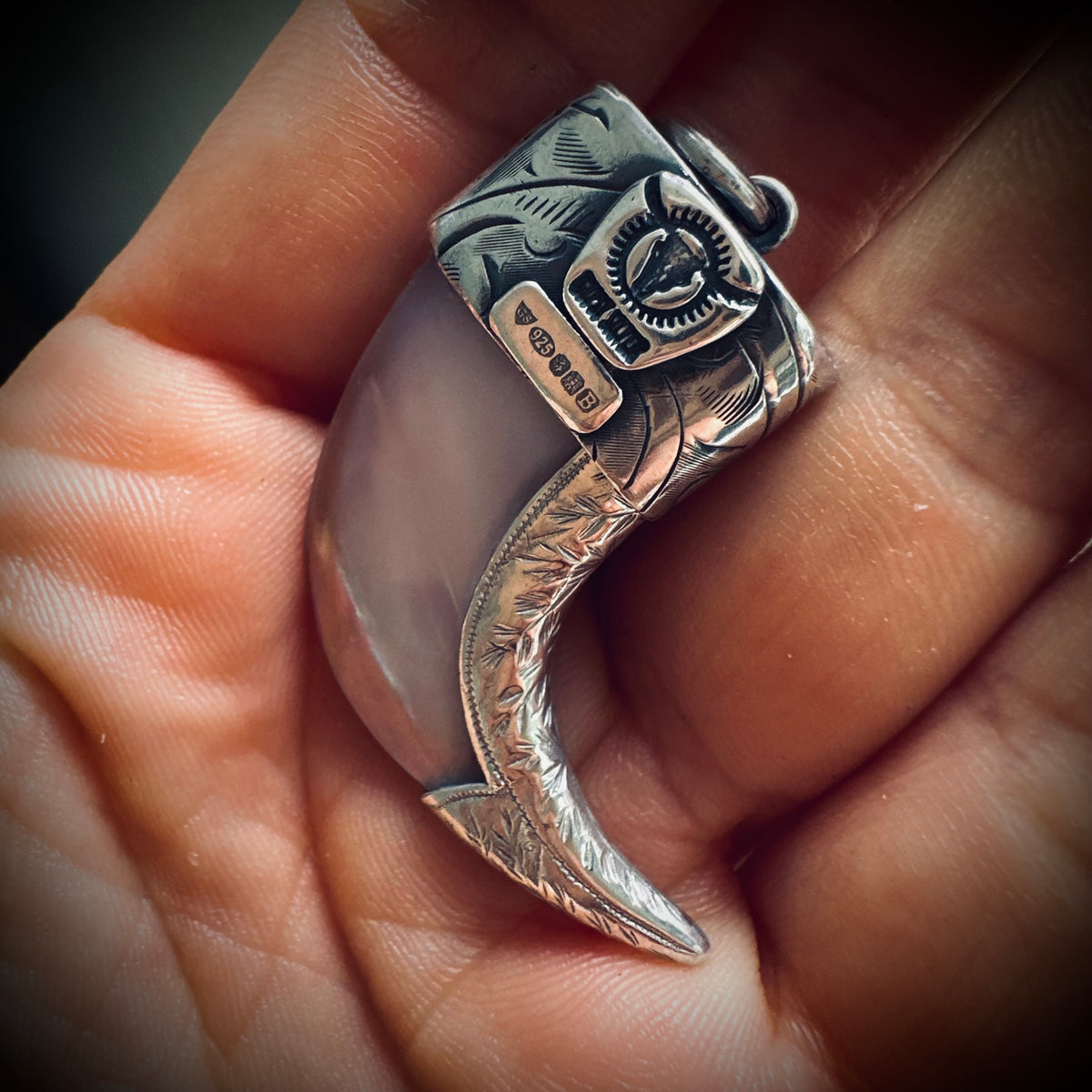Hallmarked sterling silver and turquoise claw pendant in mother of pearl