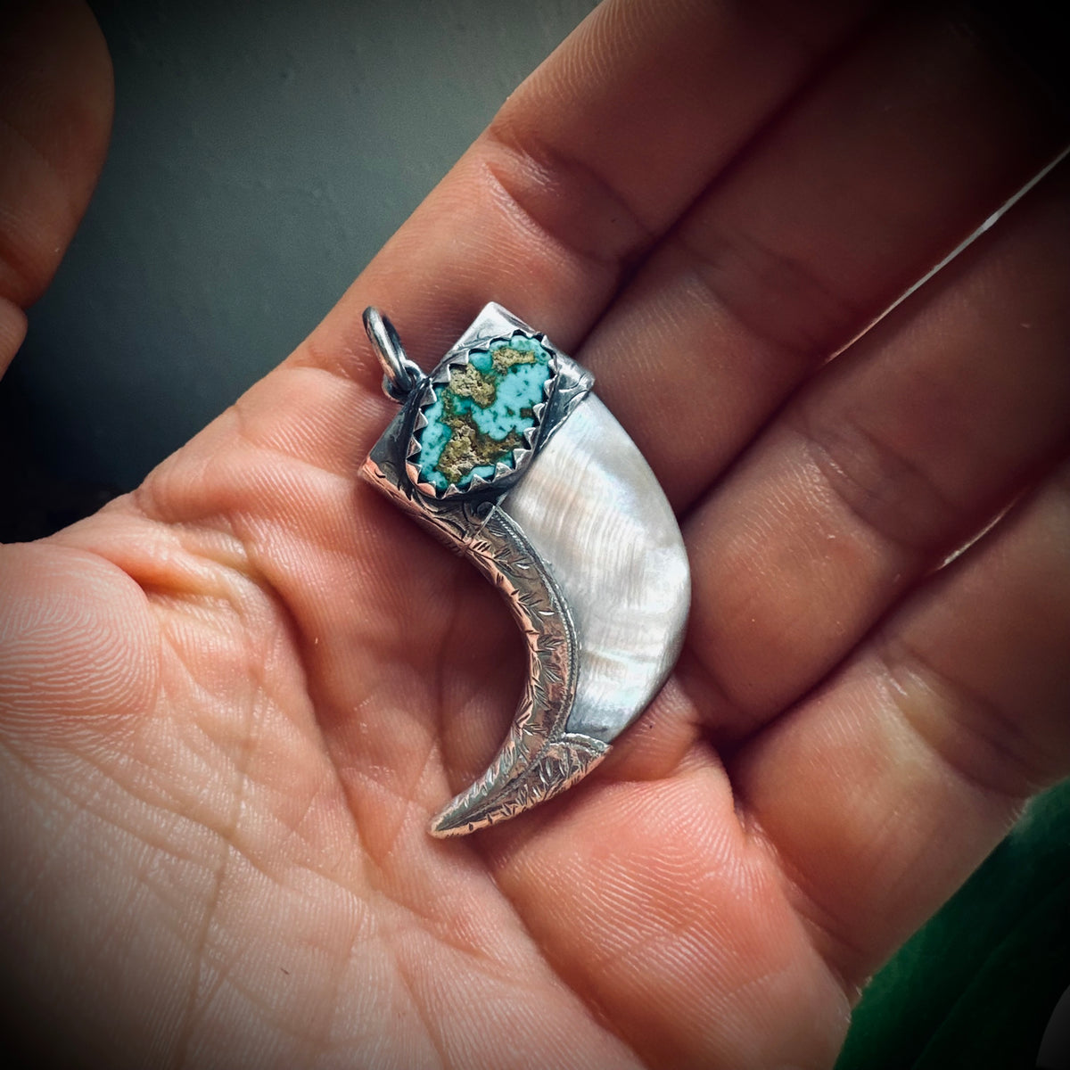 Hallmarked sterling silver and turquoise claw pendant in mother of pearl