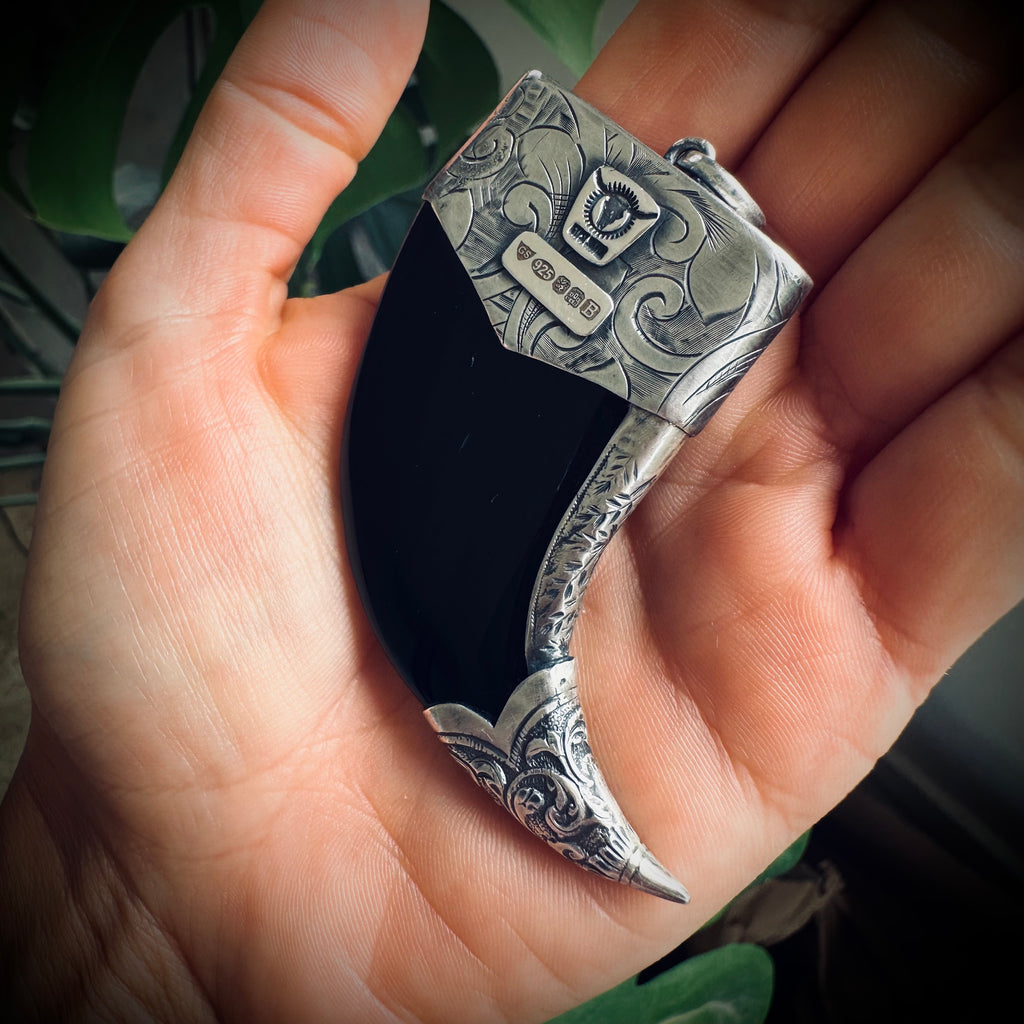 Carved onyx claw style pendant with turquoise in hallmarked sterling silver
