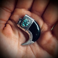 Carved buffalo horn “claw” pendant with turquoise in hallmarked sterling silver