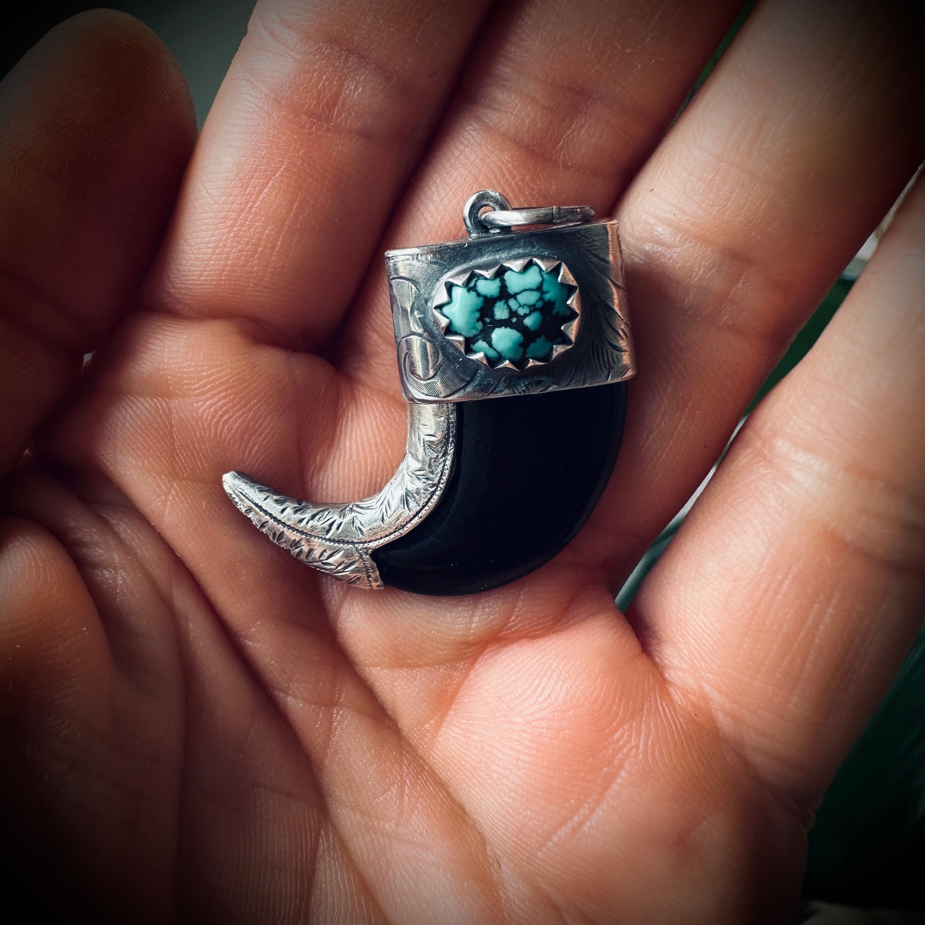 Carved buffalo horn “claw” pendant with turquoise in hallmarked sterling silver