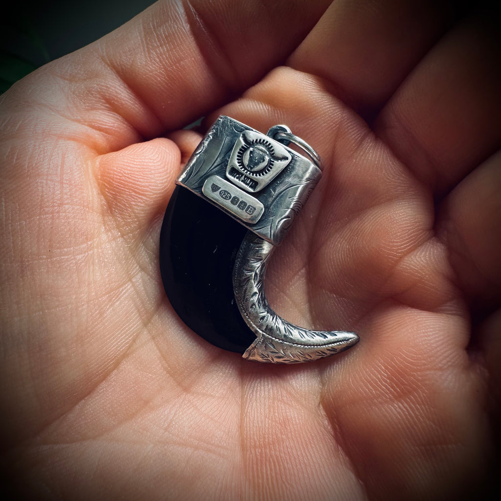 Carved buffalo horn “claw” pendant with turquoise in hallmarked sterling silver