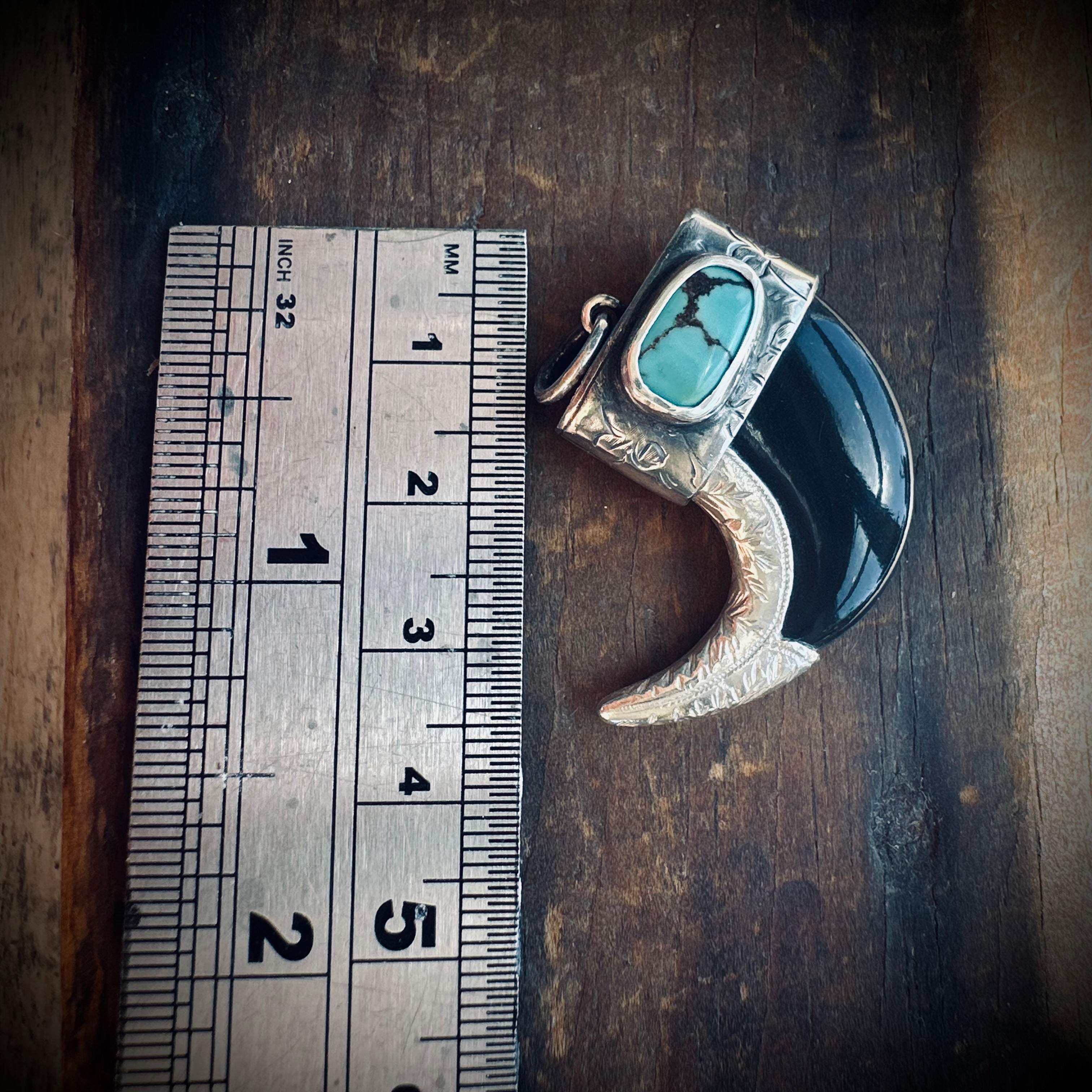 Sterling silver hallmarked claw-style pendant with turquoise and black buffalo horn