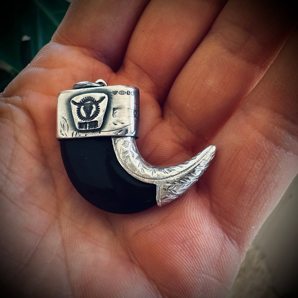 Sterling silver hallmarked claw-style pendant with turquoise and black buffalo horn
