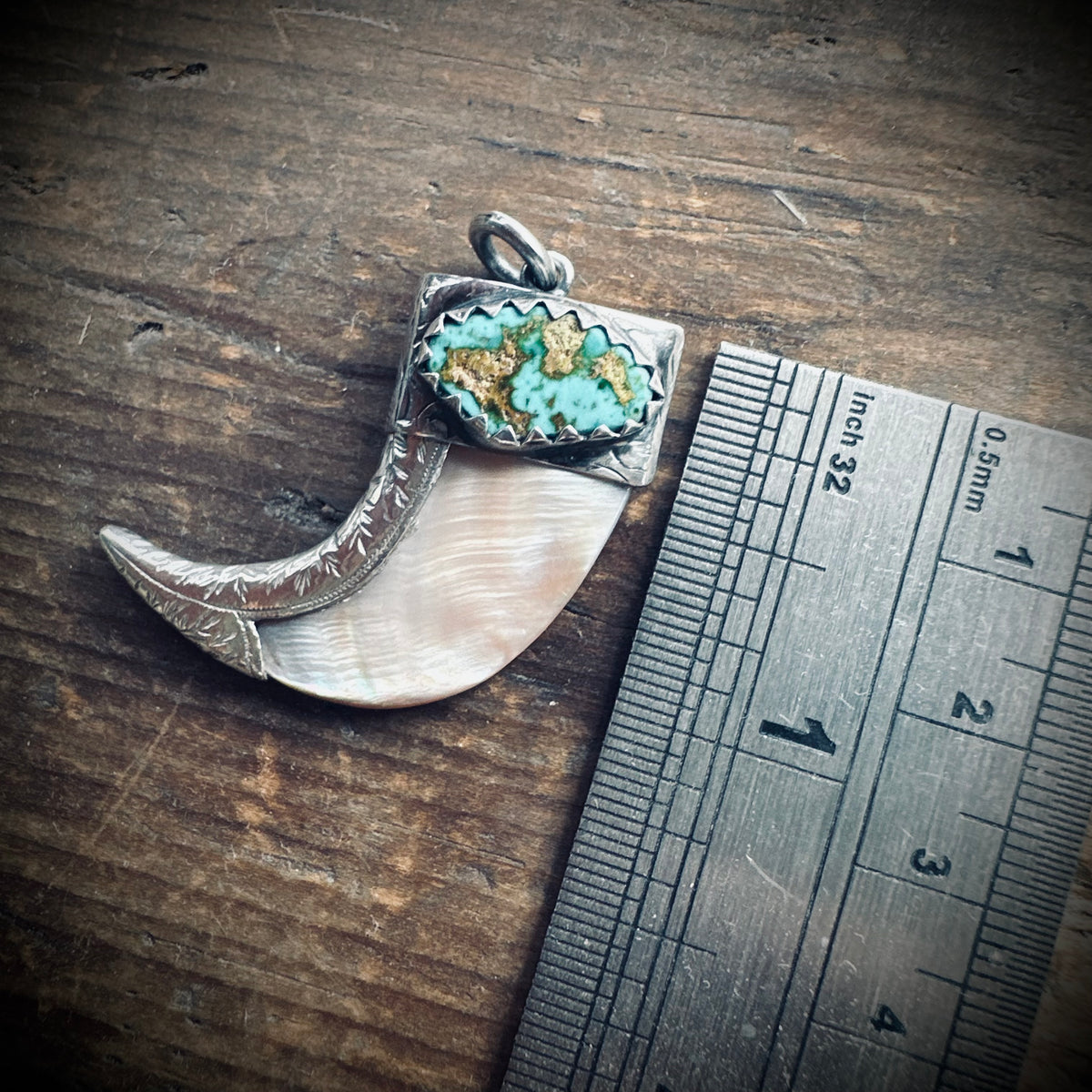 Hallmarked sterling silver and turquoise claw pendant in mother of pearl