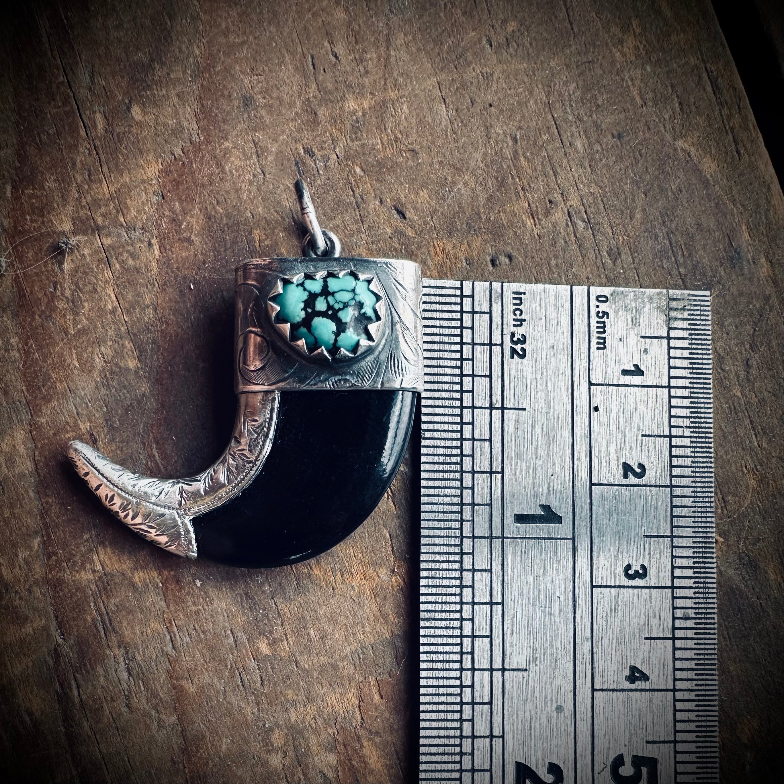 Carved buffalo horn “claw” pendant with turquoise in hallmarked sterling silver