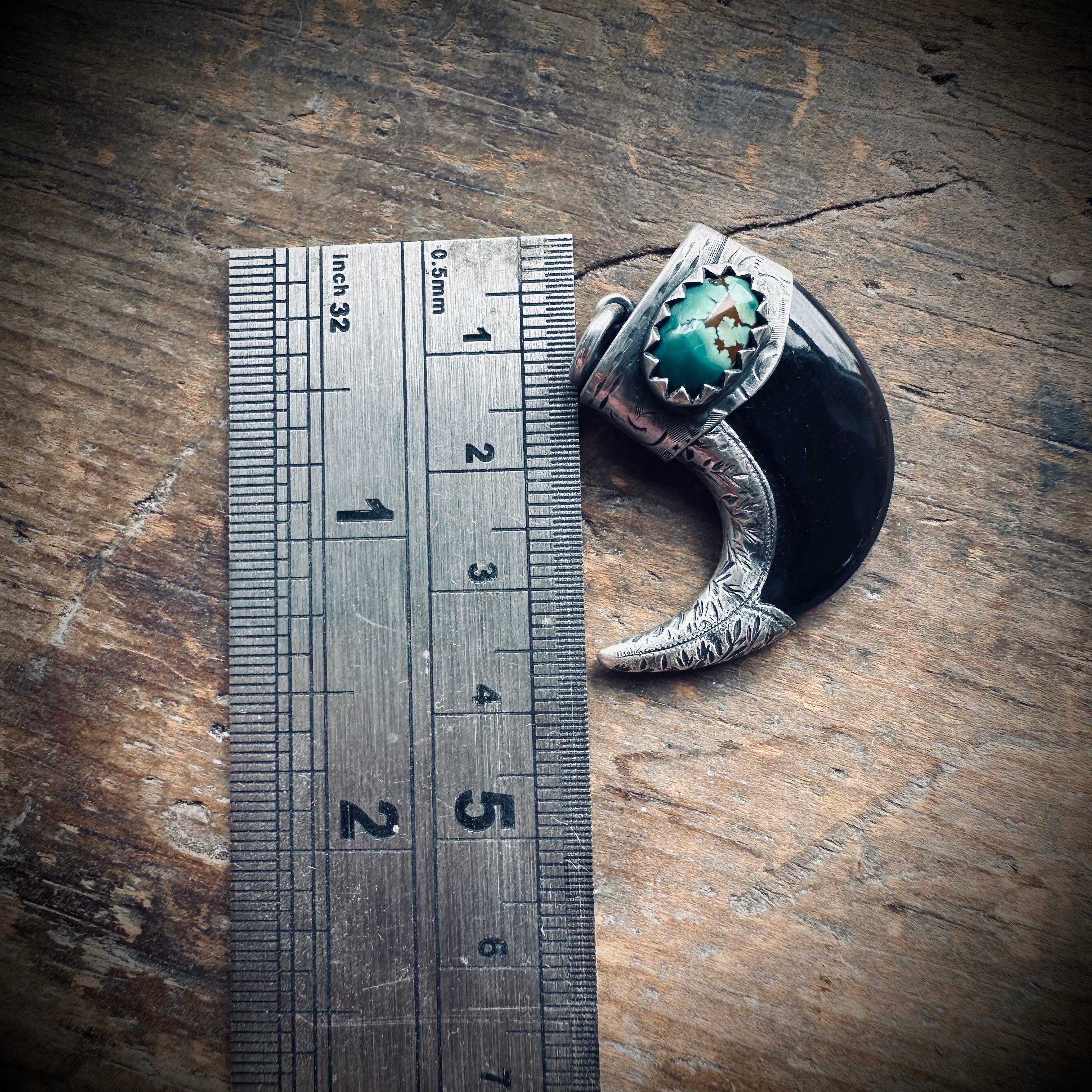 Carved buffalo horn claw style pendant with turquoise in hallmarked sterling silver