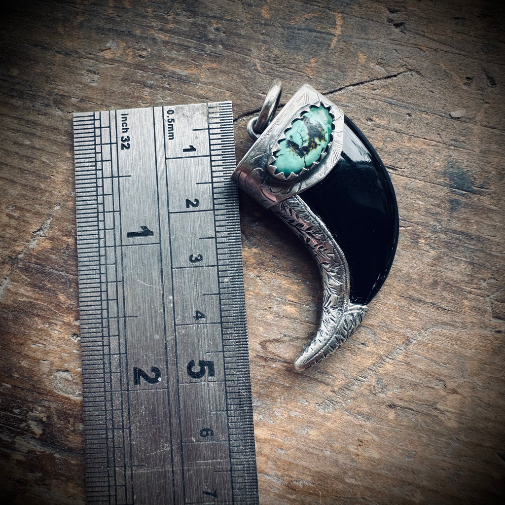 Carved onyx claw style pendant with turquoise in hallmarked sterling silver