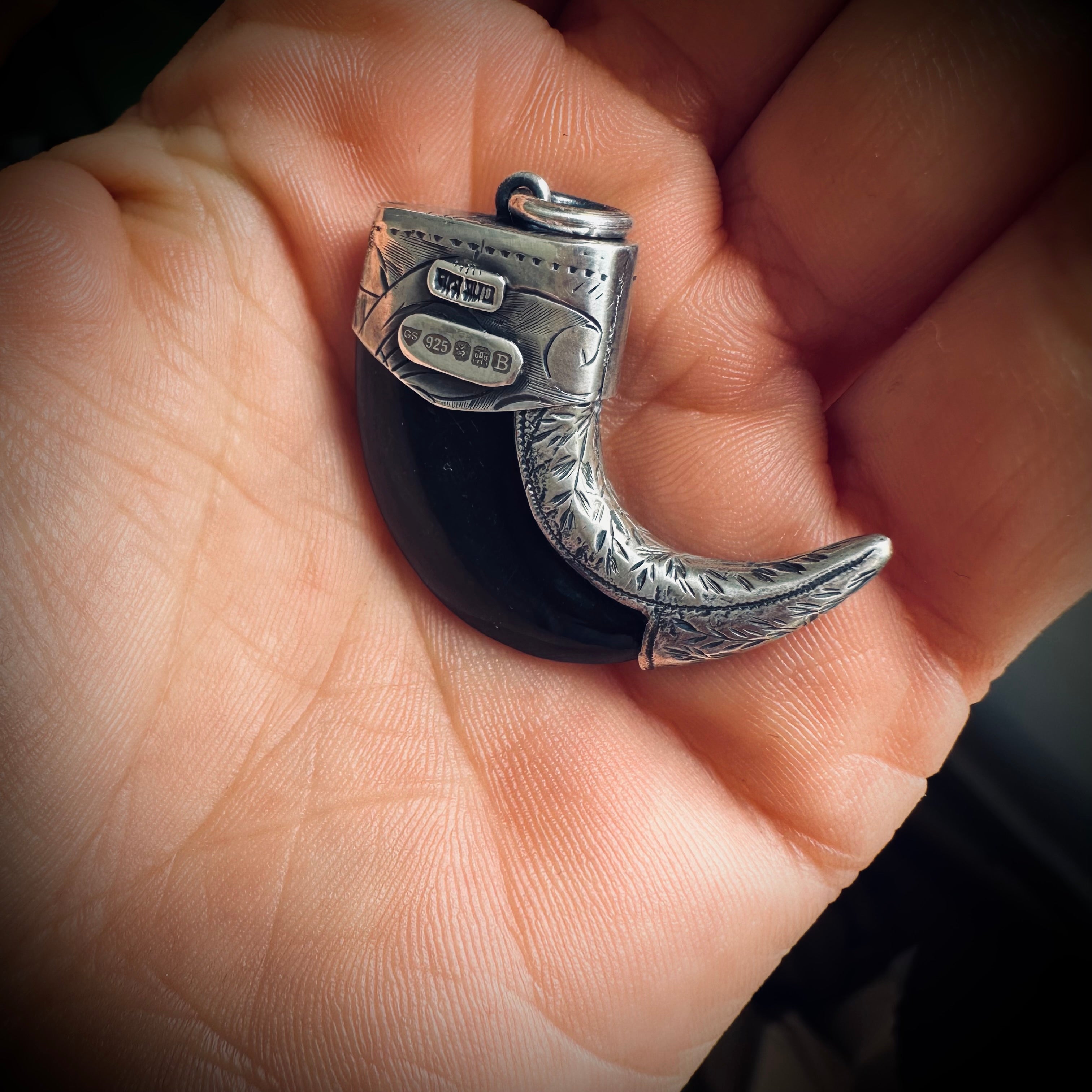 Carved buffalo horn claw style pendant with turquoise in hallmarked sterling silver