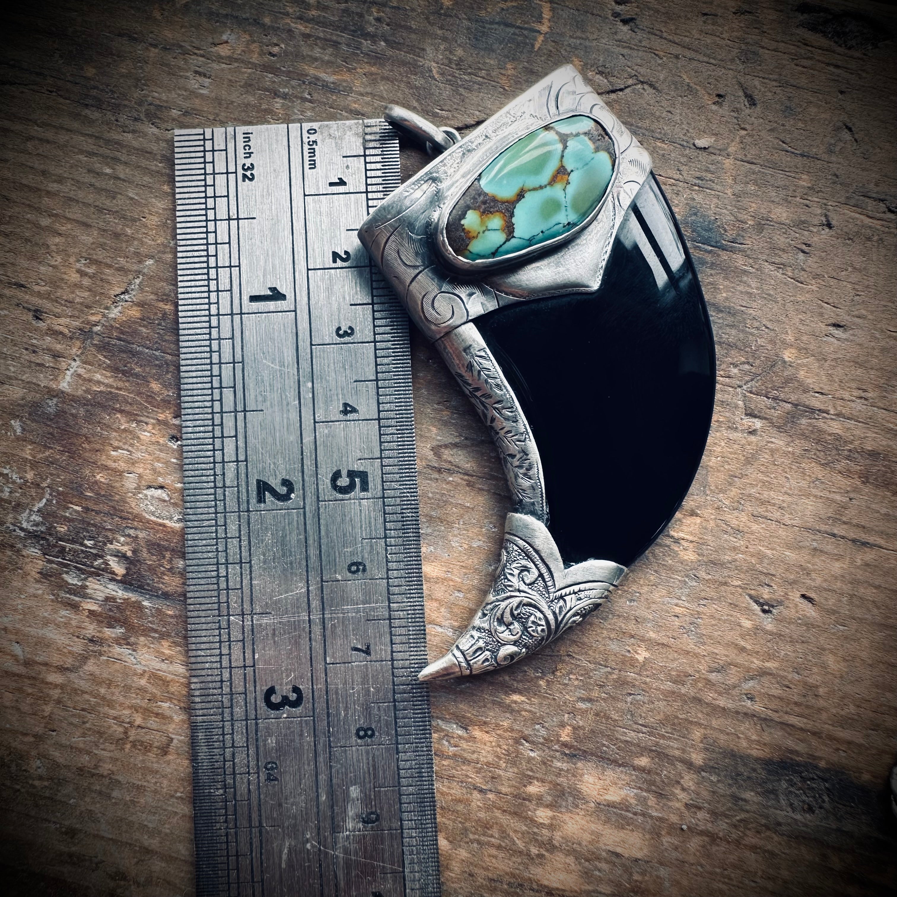 Carved onyx claw style pendant with turquoise in hallmarked sterling silver
